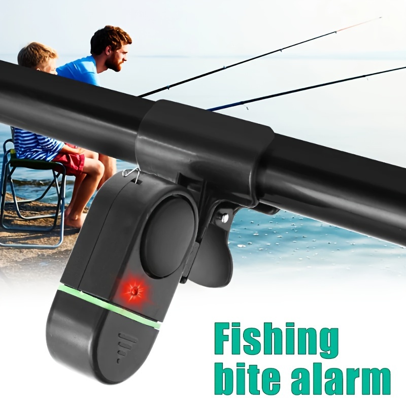 Premium Photo  Silver fishing bells are worn on a fishing rod while  fishing. bite-call signal, at the tip of the rod. a bite alarm will alert  you to a bite. fishing tackle close-up.