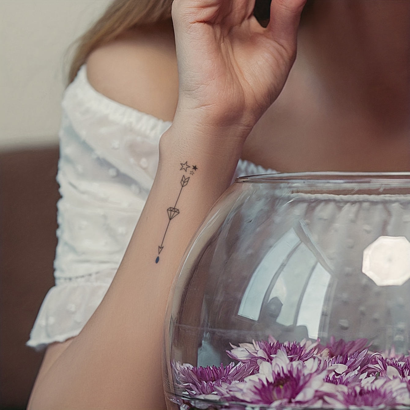 Tattoo of the word free located on the wrist.