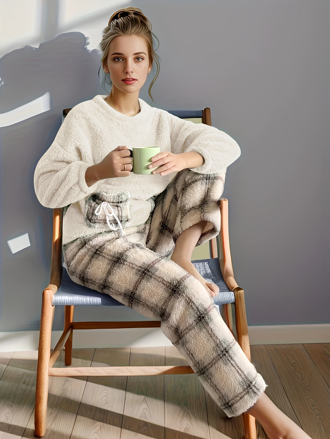 Woman dressed in comfy loungewear of grey color sitting in a cozy