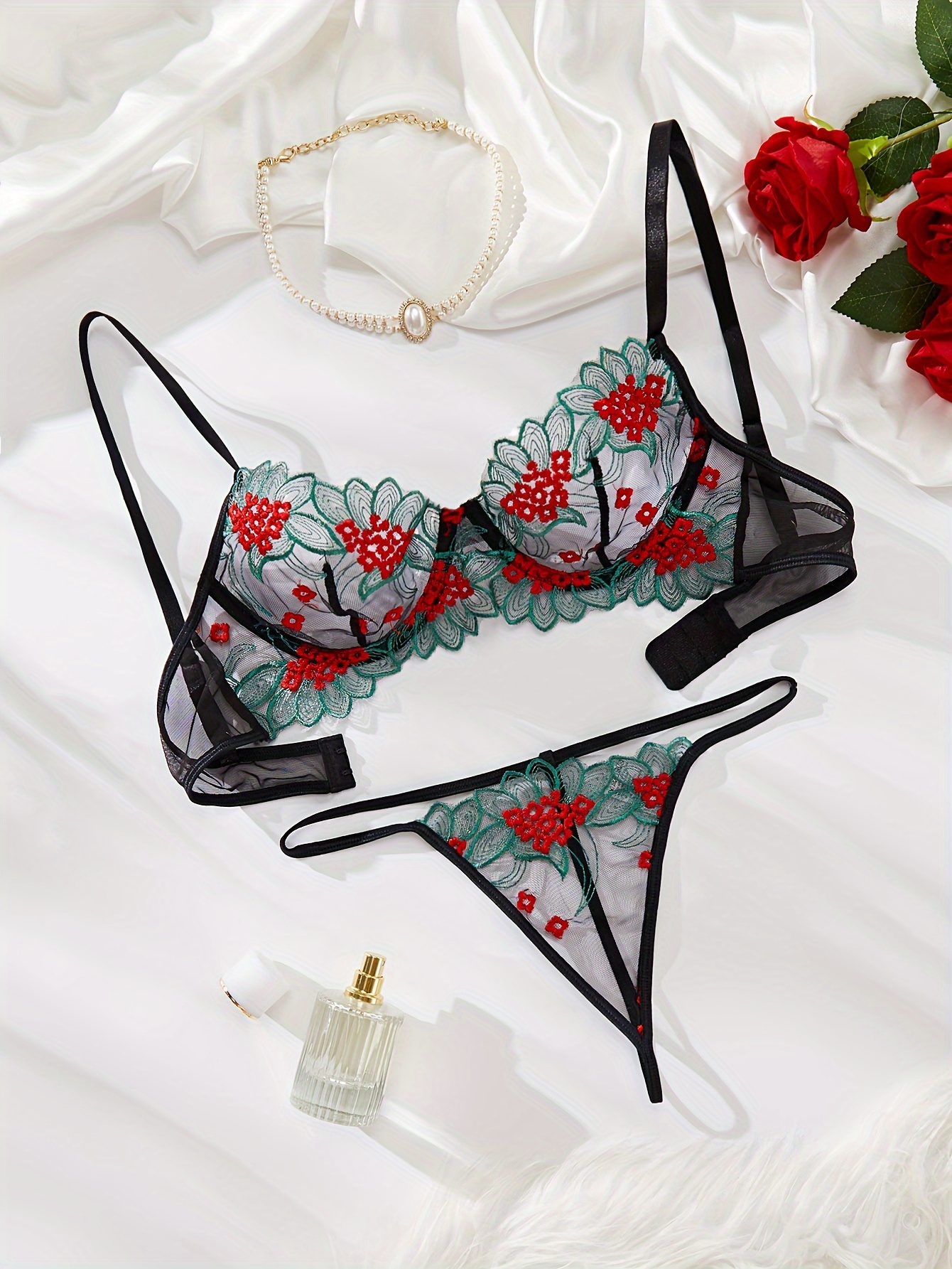 Red Lace Bra On White Background With Live Rose Flower Stock Photo