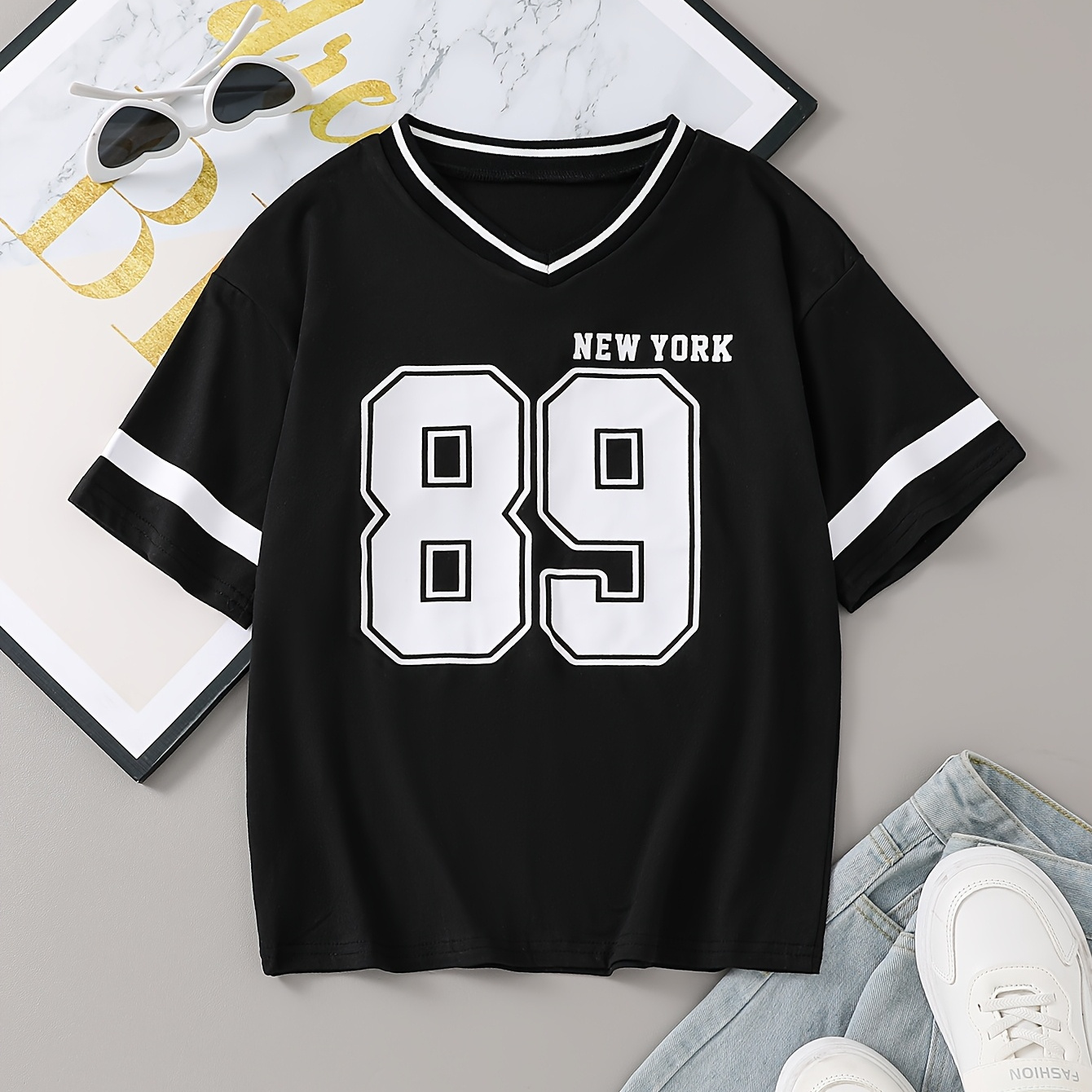Black T-Shirt with a V-Neck, Drop Shoulder Sleeves, Featuring a Stylish And Casual Design for Young Girls.