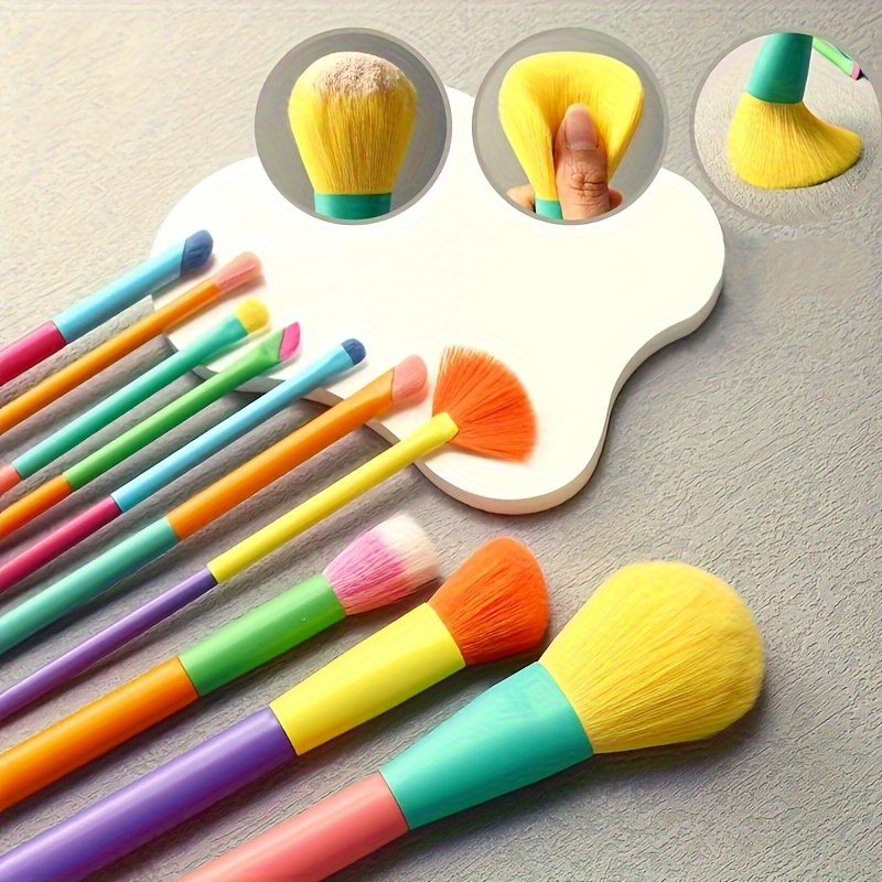 A Set Of 10 Rainbow Makeup Brushes Including Powder, Eyeshadow, Blush, Eyebrow, And Lip Brushes.