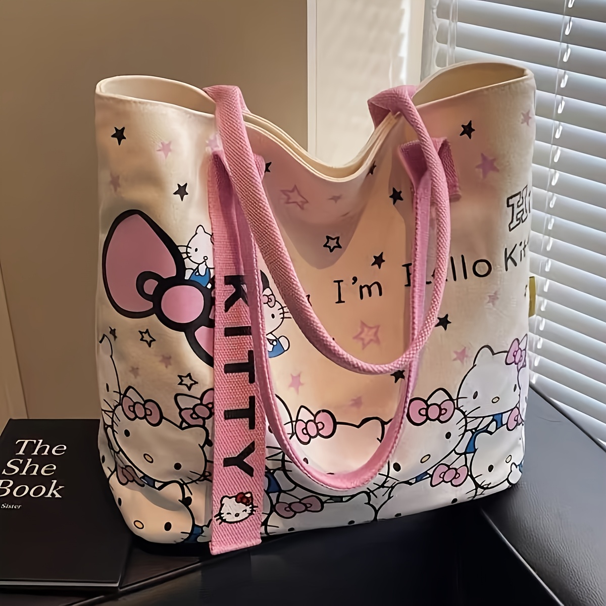       printed crossbody bag features a kitty strap and a zip closure embodying y2k fashion as a shoulder bag suitable for commuting travel and everyday use making it a great gift