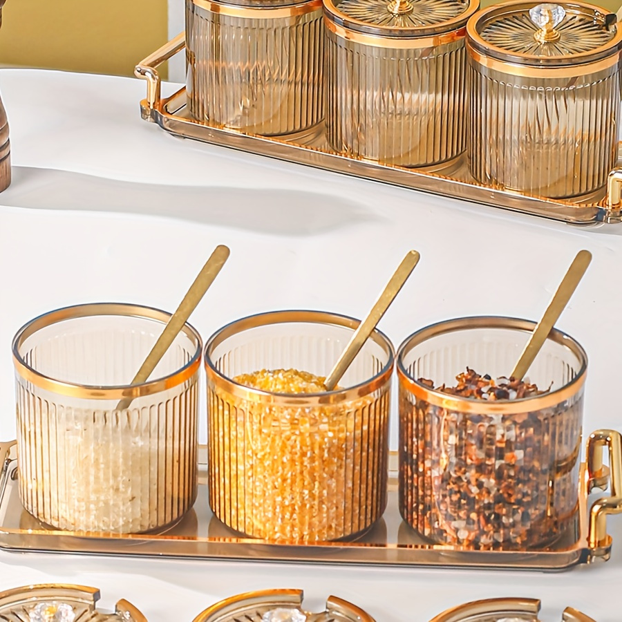 

A Stylish Set Of Seasoning Jars For The Kitchen, Featuring With And Jars, Complete With Spoons.