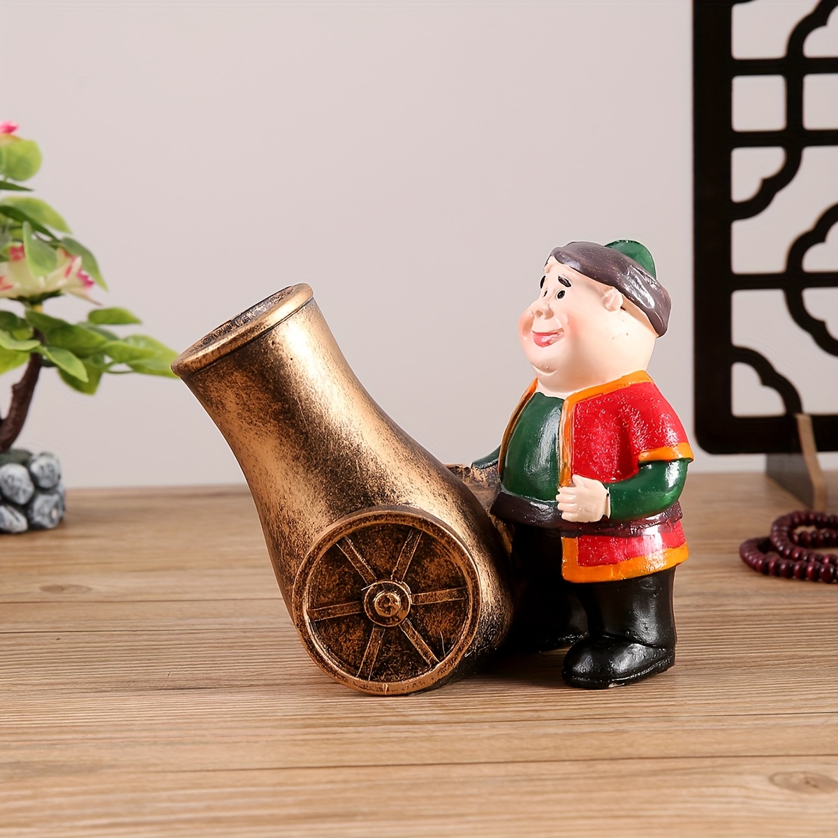 a resin figure of a chubby old man with a cannon suitable for decoration during eid celebrations Product details 7