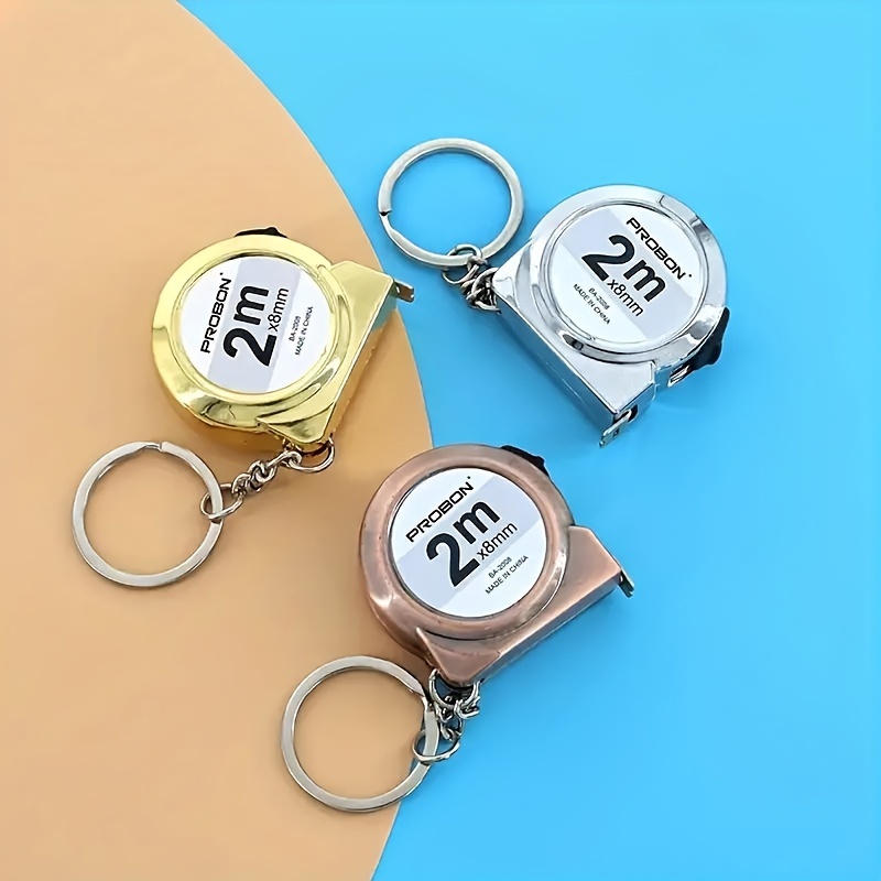 

A Mini Steel Tape Measure Keychain 2 Meters Long For Portable Use, Suitable For Hanging On A Car As An Accessory.