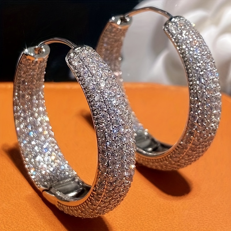 

Luxurious Circular Earrings For Ladies With Dazzling Zirconia Stones, Perfect For Weddings, Banquets, And High-end Jewelry.