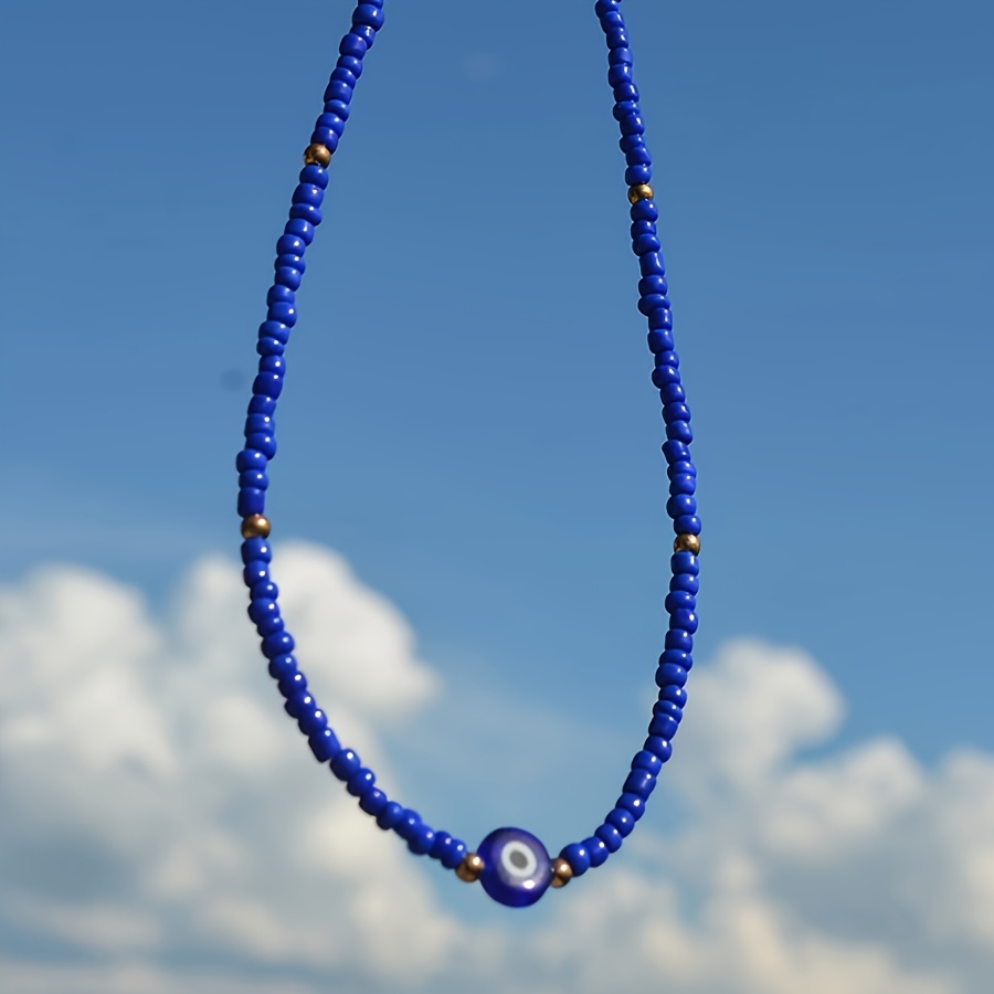 A Minimalist And Stylish Ethnic-inspired Necklace For Women Featuring A Eye And Pearl Beads