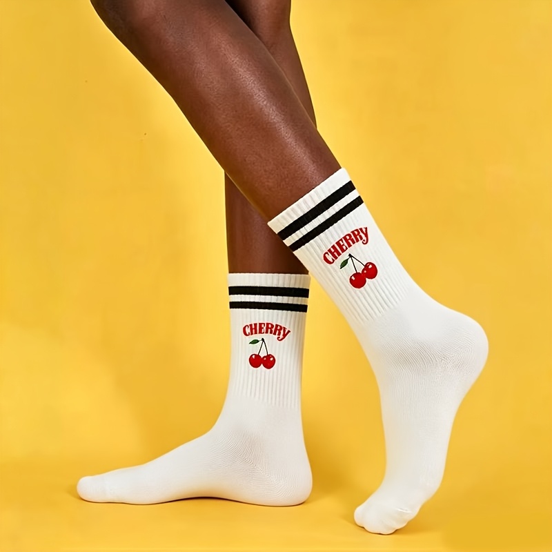 A Pair Of Black And White Sports Socks With Cherry Design For Women