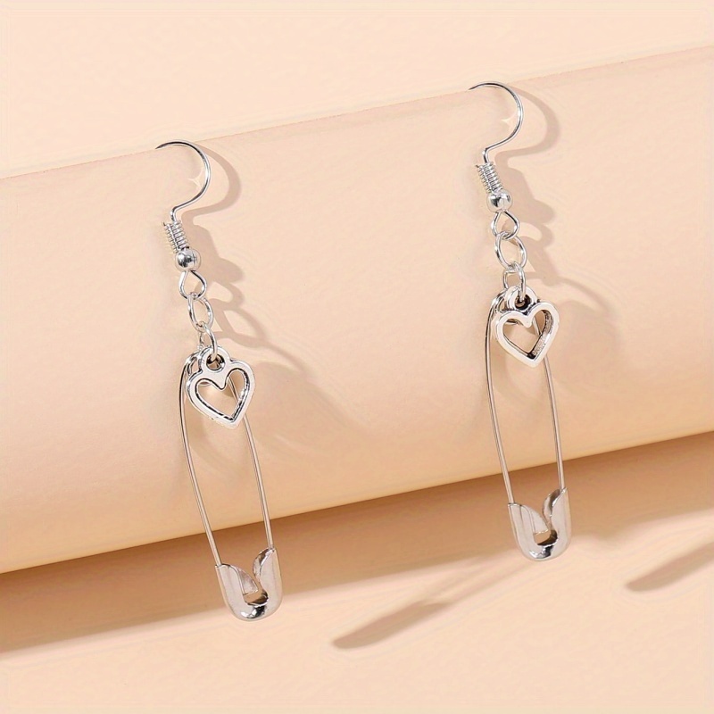 A Pair Of Heart And Safety Pin Pendant Earrings