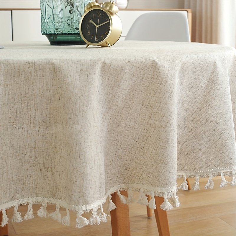 a beige round lace tassel tablecloth made of bamboo fiber