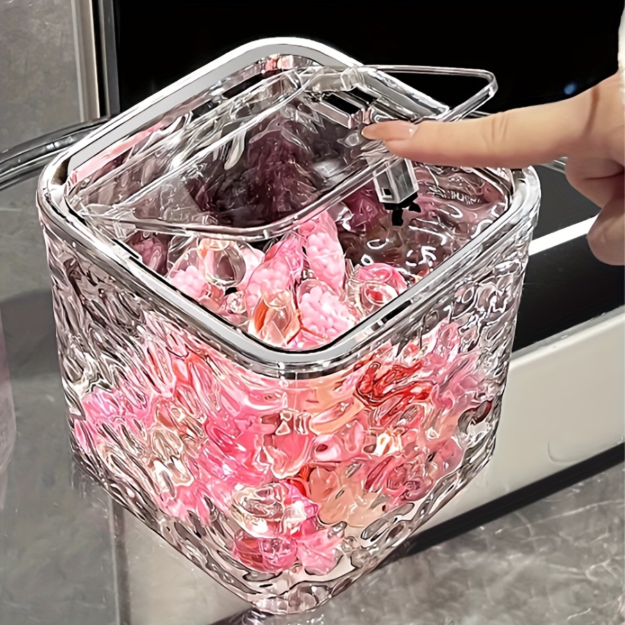 

Organisateur de Capsules de Lessive en Plastique Transparent - Conteneur de Rangement Autonome pour Détergent & Perles, Parfait pour l'Organisation de la Maison.