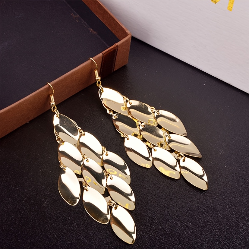 Stylish Long Earrings Shaped Like Feature Cascading Metallic Leaves, A To Any Outfit With Their Sparkling Quality
