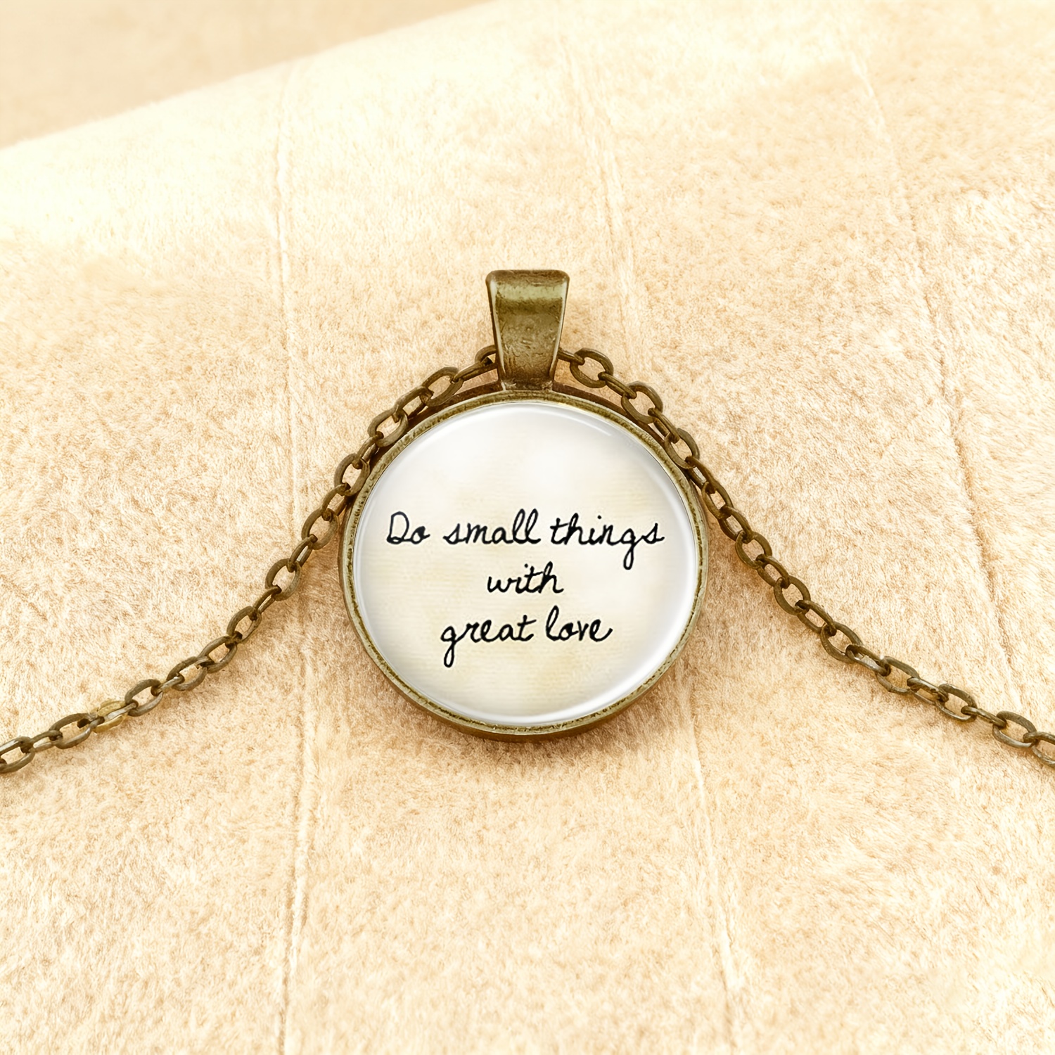 TEMU 1pc Packaging, Brown Round Base With Embedded Transparent Glass Pattern Necklace Pendant. Features Black Handwritten Text "do With " On A White