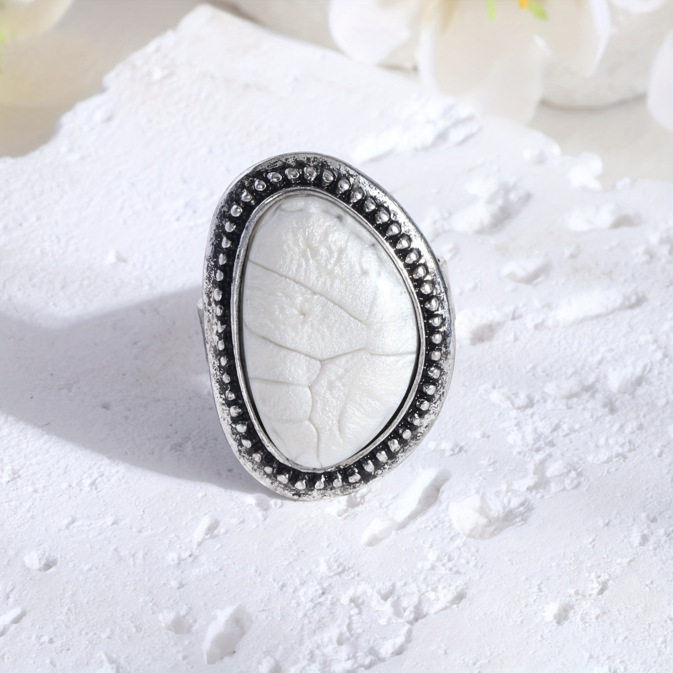 A unique stainless steel ring from the collection, featuring a luxurious vintage French ring in golden white, made of colorful natural white pearl and resin. The open design is adjustable and fade-resistant, with a simple and refined design in two styles.