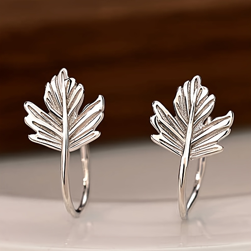 

A Pair Of Elegant Earrings With A Graceful Drop Design, Suitable For Vacation Beach Style, Featuring Maple And Tree Leaf Earrings, A Fashionable Accessory.