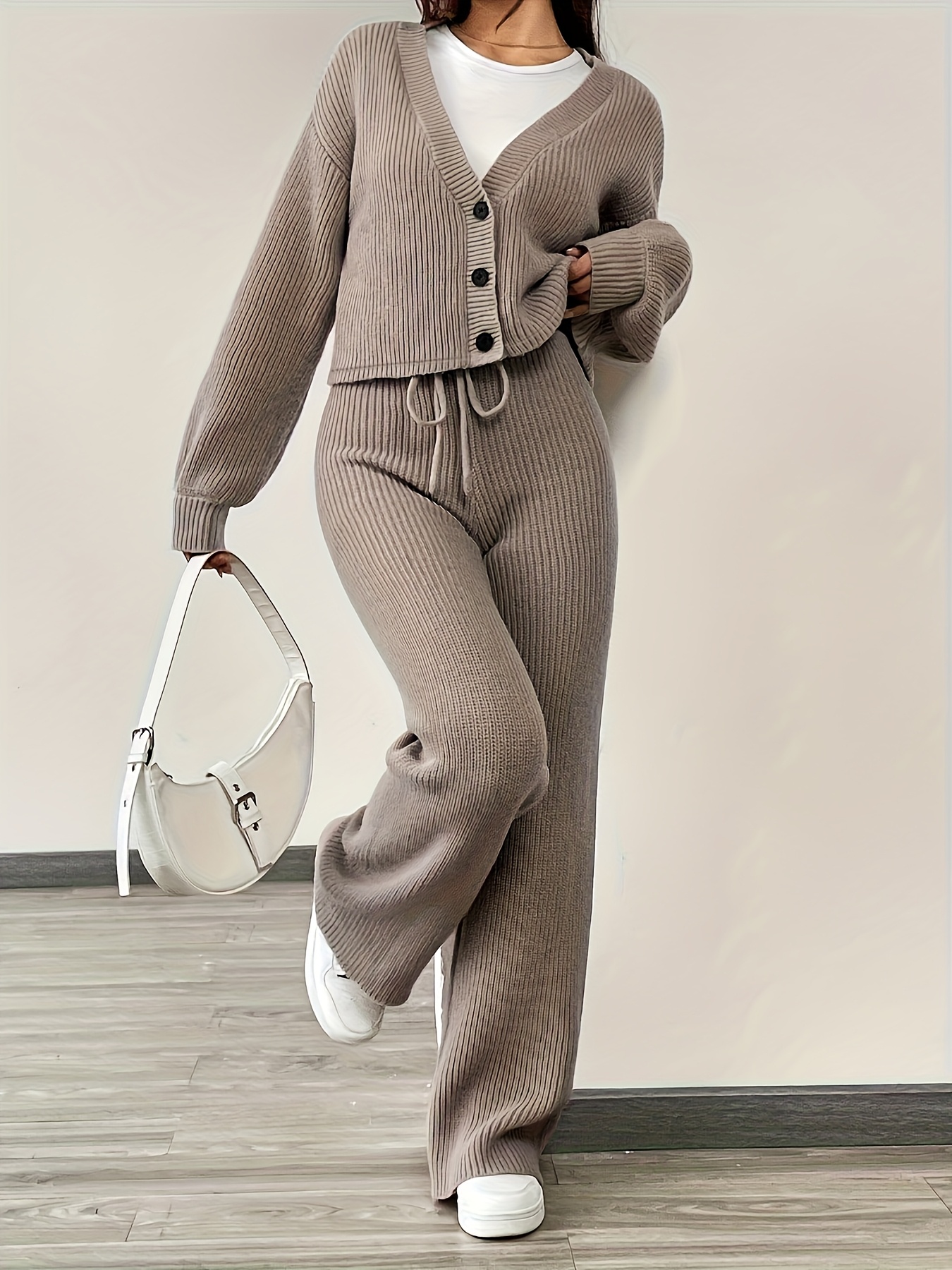 Model wearing elegant V-neck cardigan and pants set, front view