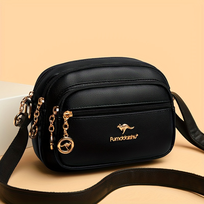 

Elegant Women's Crossbody Bag With Kangaroo Emblem - Large Capacity, Multi-compartment, Casual Leather Shoulder Bag In Black With Golden-tone Accents And Chain Strap