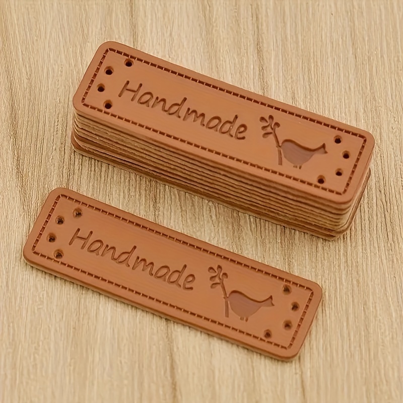 Image of 30pcs Brown Leather Handmade Labels Embossed Sewing Crafts Hang Tags, Clothing Bag Embroidery Decoration, Sewing Additions Labels