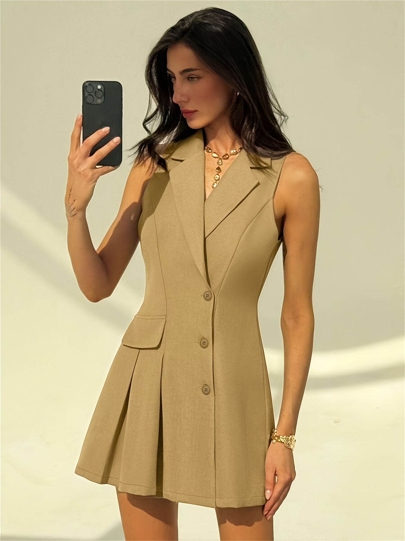 Model wearing Newness Cityscape Sleeveless Blazer Dress a sophisticated sleeveless blazer dress perfect for the office or a night out