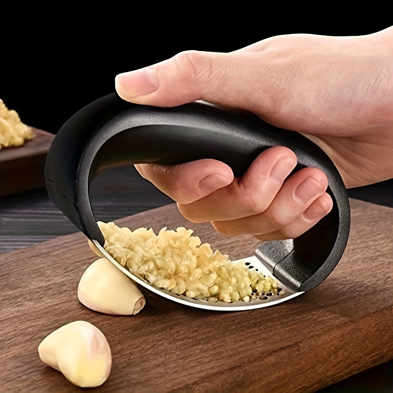 

Stainless Steel Garlic Press That Easily Crushes Garlic To Minced Garlic For Cooking.