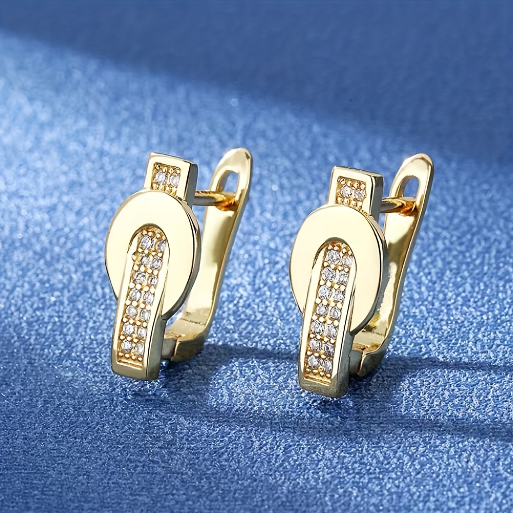 E-shop U-förmige goldene Ohrringe. U-förmiges Metall mit synthetischem Zirkonia eingelegt, niedliche kompakte Damen-Ohrringe, modische schlichte