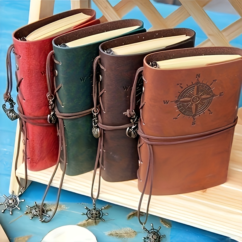 

A Vintage Leather Notebook With A Matte - Features An Antique Pirate-themed Maritime Compass Design, Hardbound Writing Journal With A Metal Clasp And Spiral Binding.