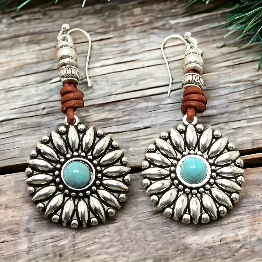 

A Pair Of Vintage Turquoise-inspired Sunflower Pendant Earrings In A Western Cowboy Style, Featuring Trendy Cord Designs Suitable For Wear At Music Festivals And Parties.