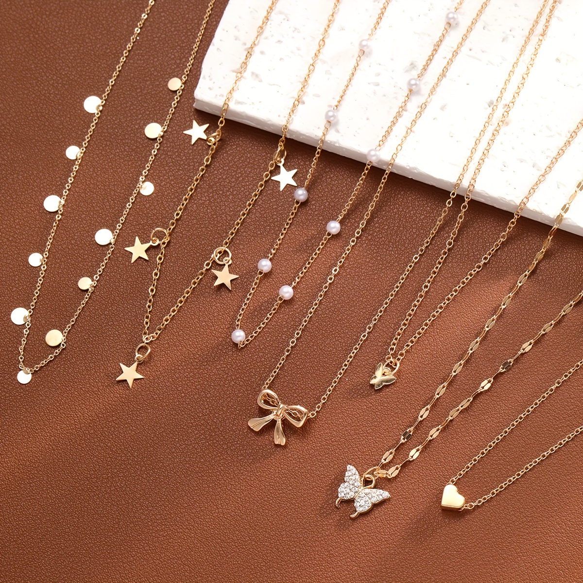 

Elegant Gold-tone Necklace Set: Featuring Butterfly, Star, Bow, And Heart Pendants - Perfect For Everyday Wear And Beach Parties