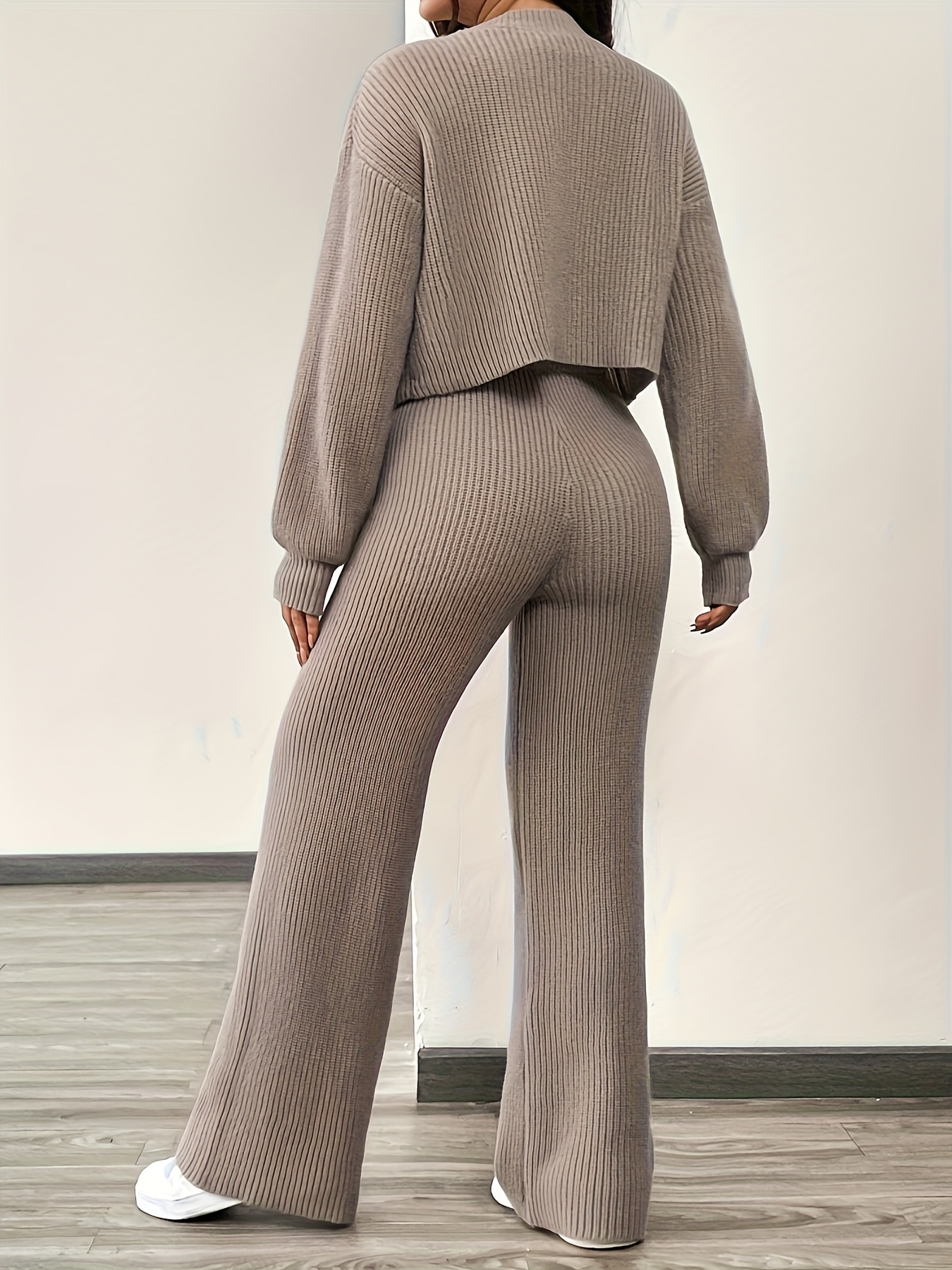 Side profile of model wearing the knit cardigan and trousers