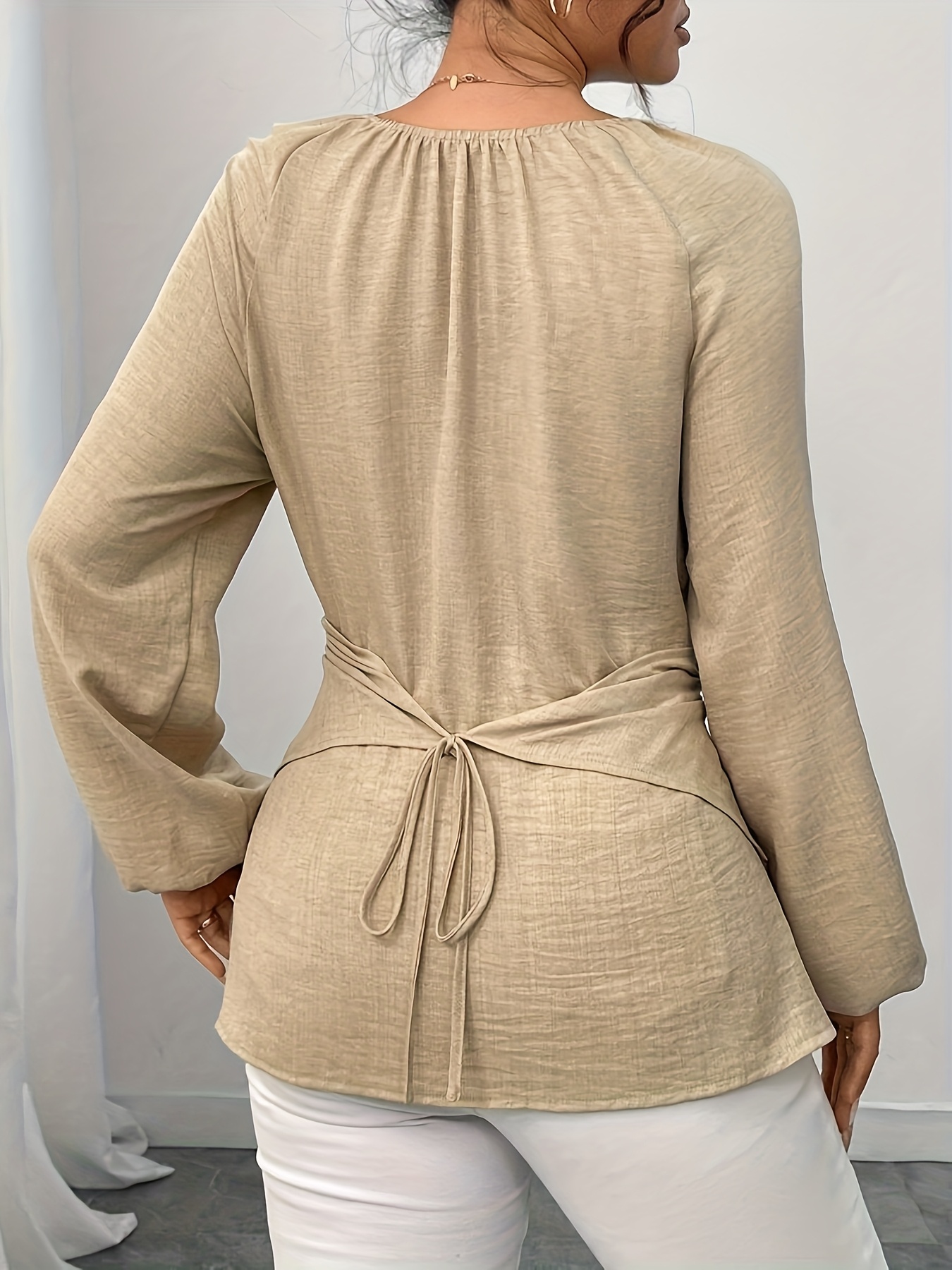 An Elegant Long-Sleeve Shirt for Women, Featuring a Beaded Wrap Design with a Solid Color And Faux V-Neck Decoration, Designed for Autumn And Winter with a Shorter Front And Longer Back