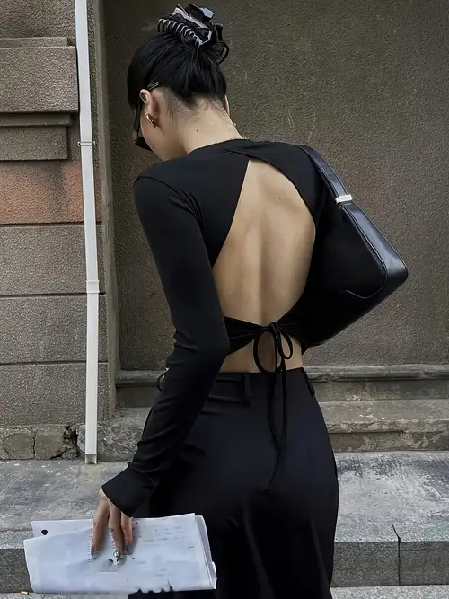 backless t shirt dress This wonderful dress is the @area Crystal Embellished Backless T-shirt dress. This T-shirt dress features short sleeves and an open back. It has a loose and flowy cut and can easily be