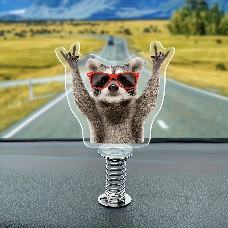 A 2d Flat Raccoon Figurine With A Swinging Motion, Made Of Acrylic Spring Decoration And Sporting Stylish Red Glasses - A Fun Accessory For Car Dashboards, Suitable For Cars, Trucks, And Suvs