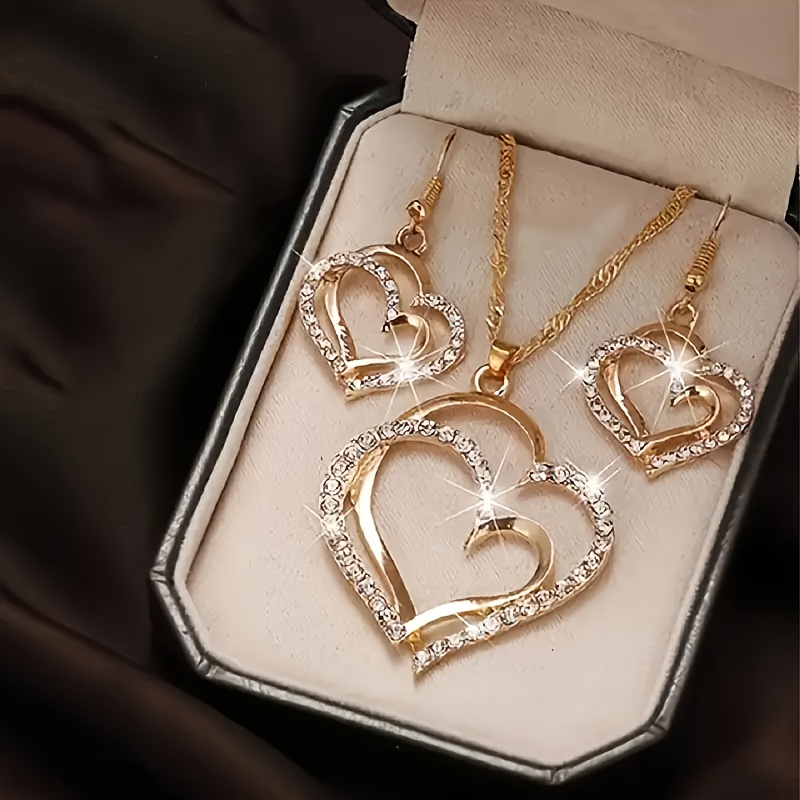 a creative and unique jewelry set consisting of 1 pair of earrings and 1 necklace featuring a sparkling heart shaped design with shiny rhinestones   accessorizing daily outfits or party wear details 0