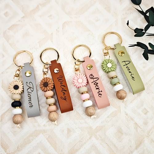 a custom daisy bead keychain featuring a name and floral charm soft colored and lobster clasp closure an elegant gift suitable for women teachers birthdays christmas weddings valentines day