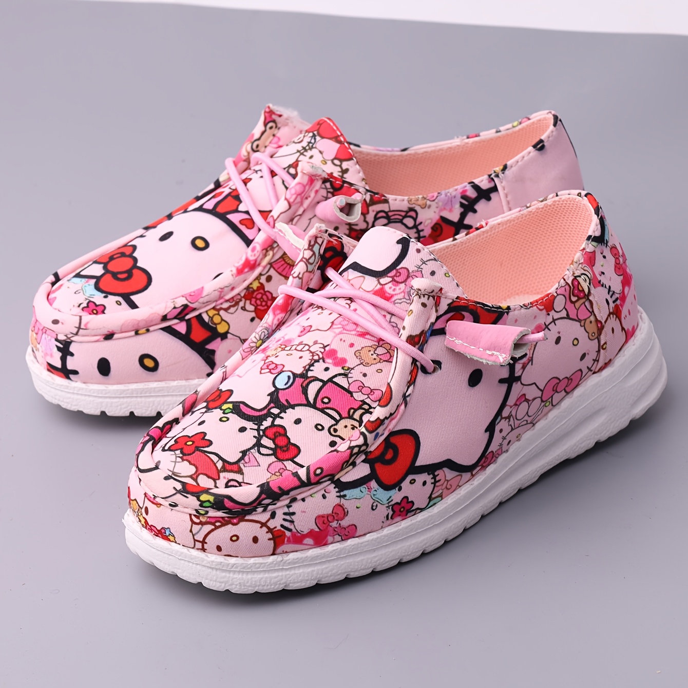 casual athletic footwear for girls featuring a low cut design ideal for   indoor and outdoor use offering a flat and   resembling kt cat loafers