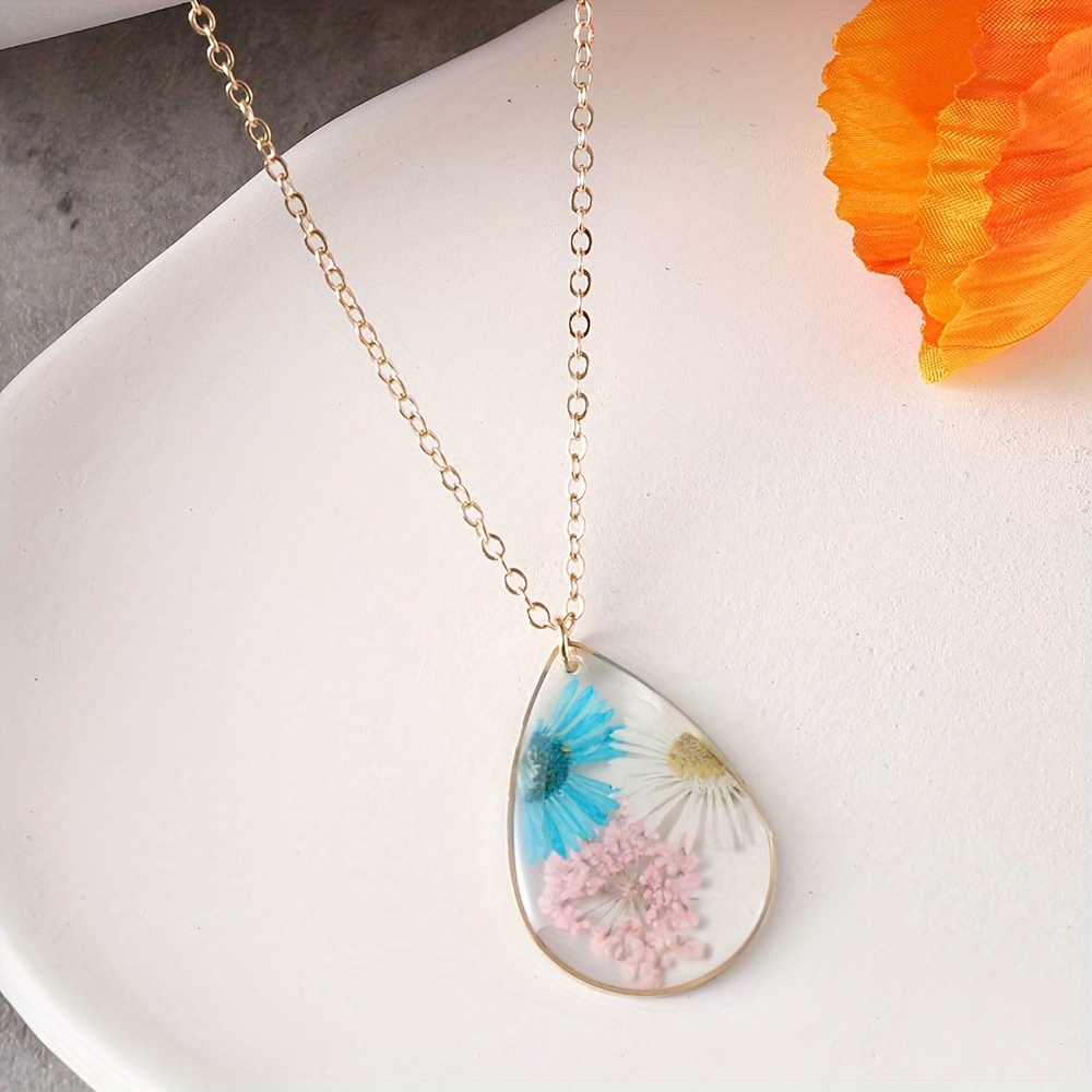 Elegant resin necklace with dried, factory real flower inside.