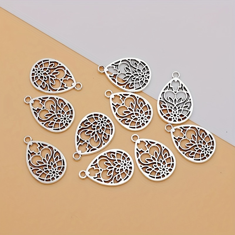 Image of 10pcs Of Hollow Heart Flower Drop Charms Made From Alloy, Perfect For Crafting Bracelets, Earrings, And Necklaces. Ancient Silvery-colored Pendants Are Ideal For Handmade Projects