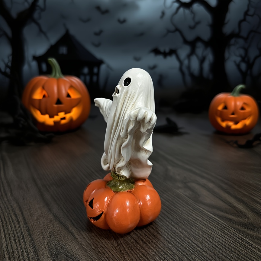 a halloween ghost figurine standing a pumpkin made resin