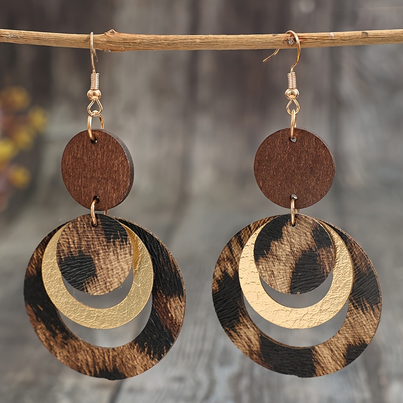 Image of A Pair Of Stylish Women's Earrings Featuring A Design With Multiple Layers And Leopard Print Cutouts In Faux Leather