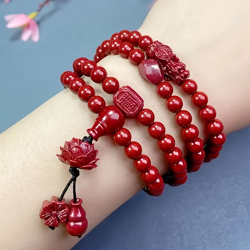 A Red Bracelet Featuring 108 Beads, A Pixiu, And A Lotus Design, With Purple Round Beads, A Bracelet