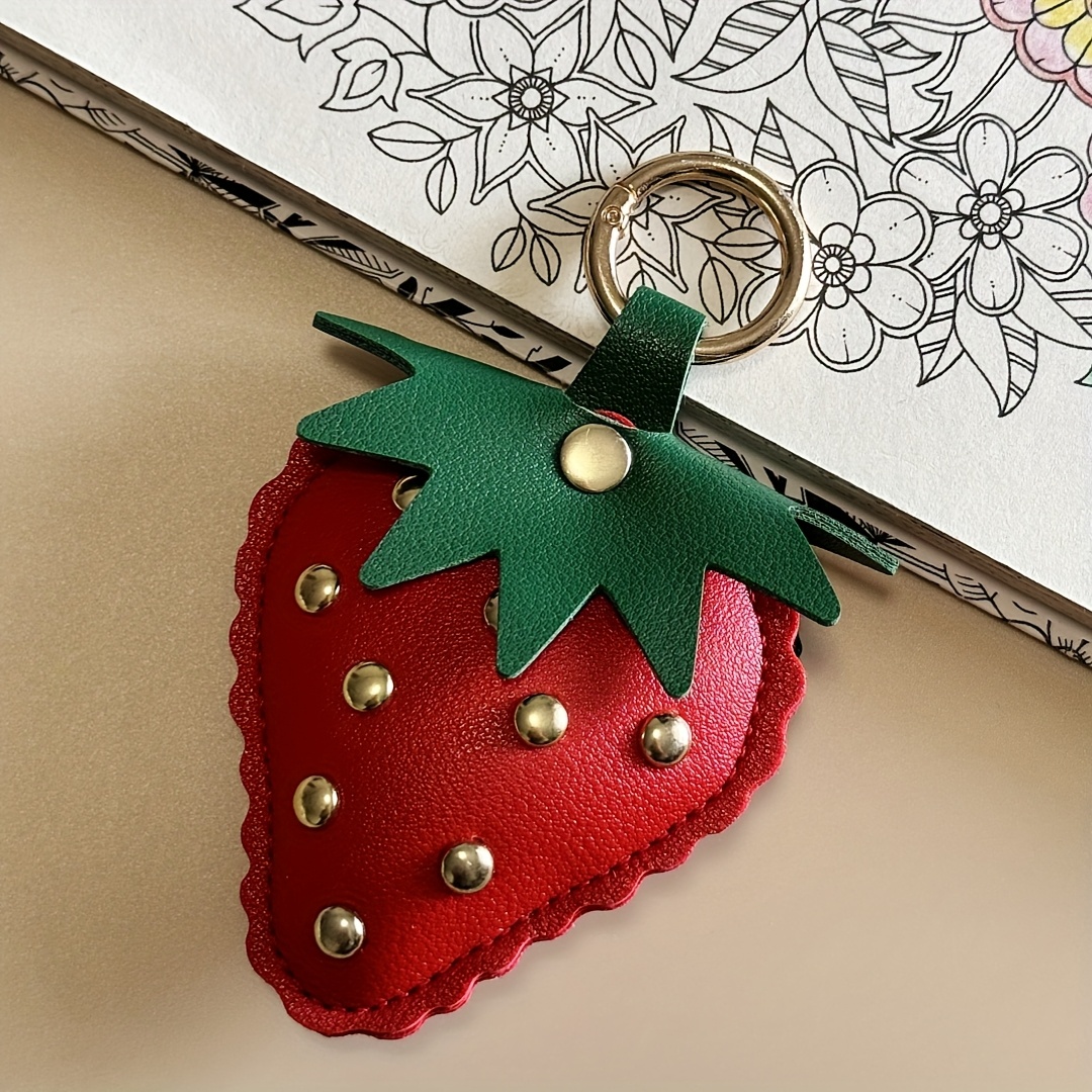 Image of An Elegant Strawberry Keychain Made Of Faux Leather, Featuring A Studded Design, Suitable For Bag Decorations And Car Key Additions, Making It An Ideal Gift For Women