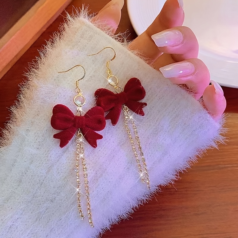 

A Pair Of Red Bow Long Tassel Earrings With Design And Temperament Earrings
