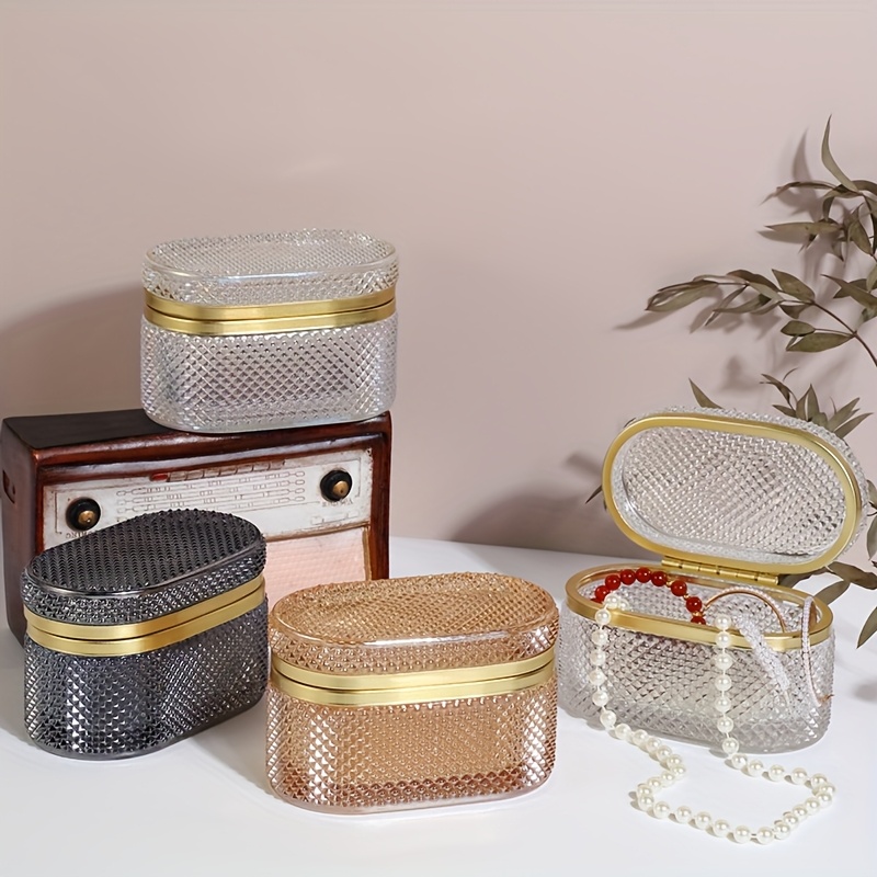 modern clear glass storage box with golden accent lid dustproof oval desktop organizer for jewelry makeup pads and accessories polished   multi purpose   metal interior no power needed makeup storage contemporary style textured glass jewelry boxes Product details 0