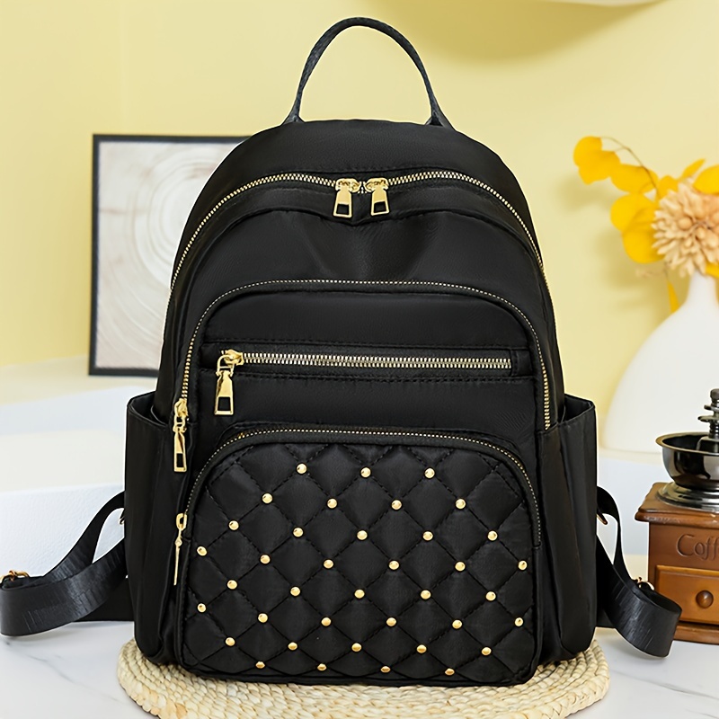 Sleek Commuter Chic Black Nylon Travel Backpack with Adjustable Straps Tassel Detail Lightweight Large Capacity School Casual Bag