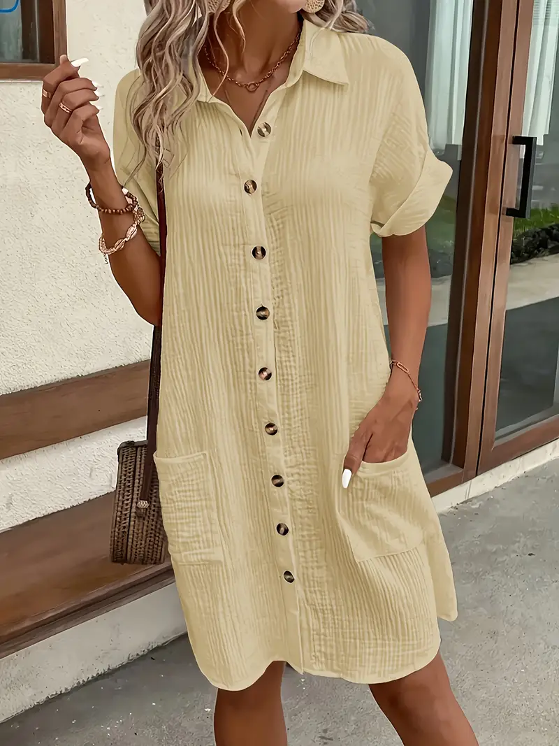 a minimalist white shirt dress made of breathable featuring a sharp collar design and buttons that add a touch of details 8