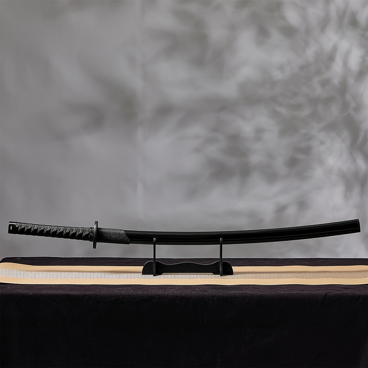 Training sword on a stand with a textured gray background