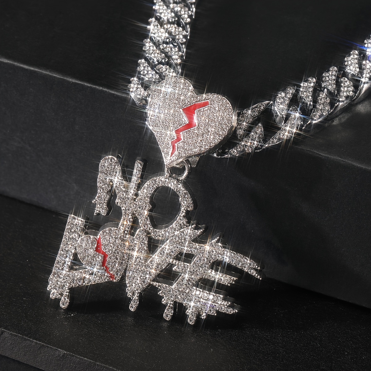 

A Necklace With A Cracked Rhinestone Pendant Symbolizing The Absence Of Love In Men's Lives, Inspired By Hip Hop Culture.