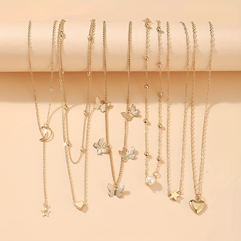 E-shop Bohemian-Stil 6-teiliges Halsketten-Set mit Stern-, Mond-, Schmetterlings- Herz-Anhängern – Eleganter Zinklegierung-Schmuck geeignet für Partys,
