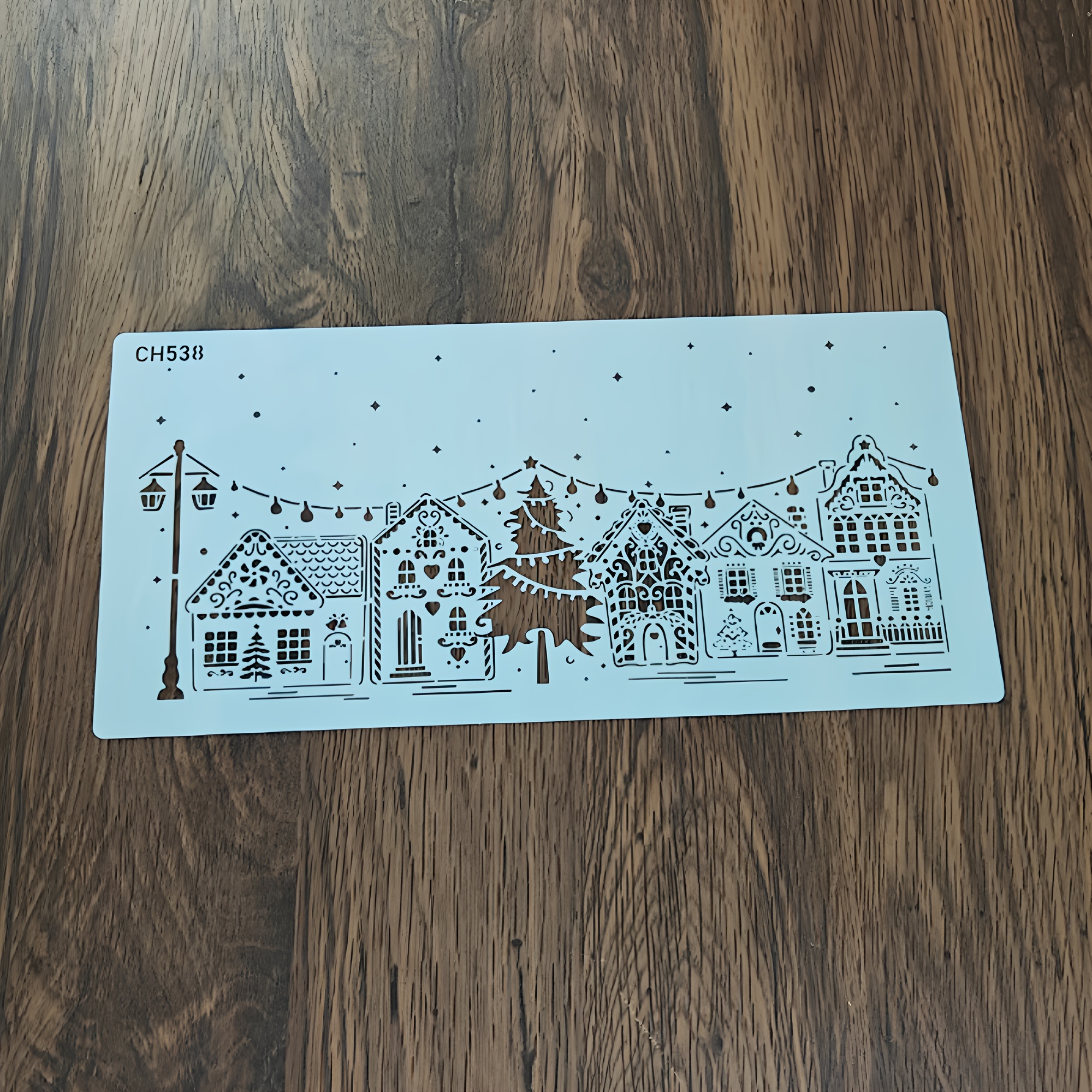 Image of Cake Decorating Stencil For Christmas Featuring A Tree And House Design, Made From Food-grade Pet Material, Suitable For Wedding And Birthday Party Cakes, Desserts, And Fondant Cake Decorations